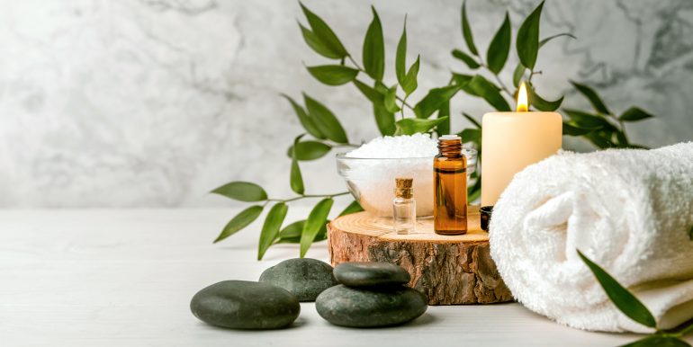 beauty treatment items for spa procedures on white wooden table.